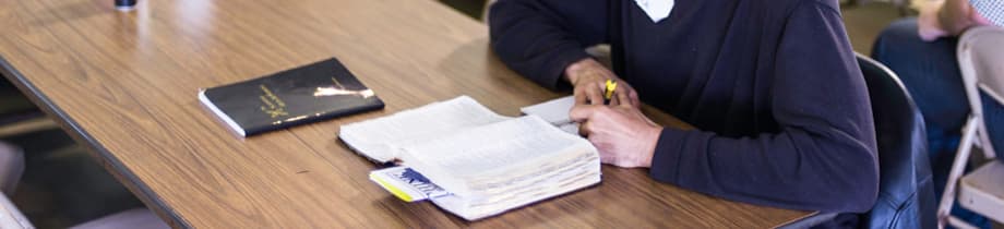 An open Bible and notes on a table